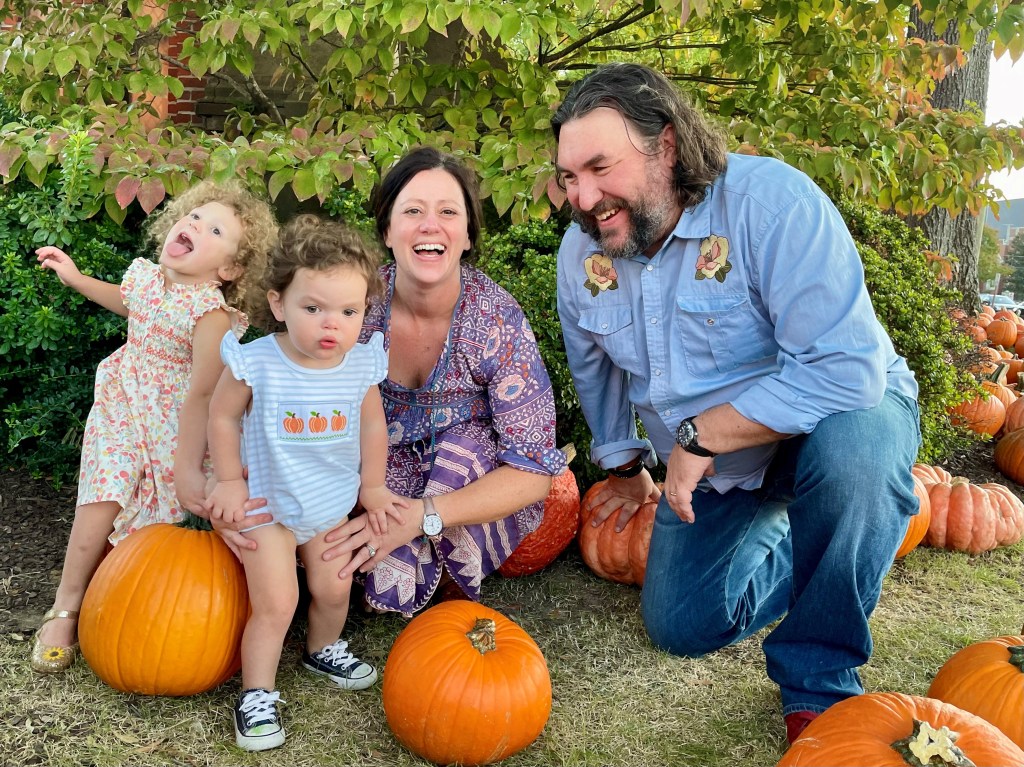 Wright Thompson smiling with his wife and two kids